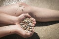 Sea Ã¢â¬â¹Ã¢â¬â¹shells and children`s hands on the sea close-up.  Teenager boy holds many sea shells in his hands.Background and Royalty Free Stock Photo